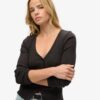 Essentiële top met lange mouwen en knoopsluiting
