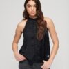 Kanten mouwloze top met hoge hals Kanten mouwloze top met hoge hals